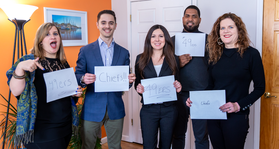 Fran, Chris, Tracy, Dionel & Meredith holding up a sign of their SuperBowl team