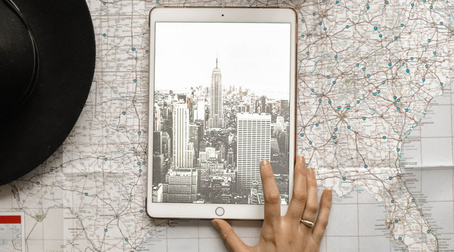 hand on tablet with map