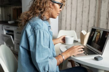 woman with laptop on webinar