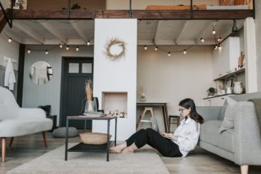 Woman sitting on floor working on laptop