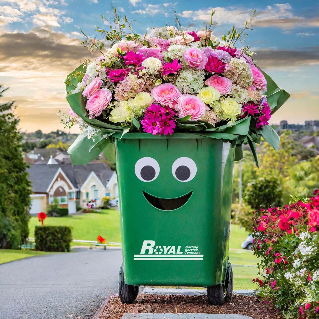 Royal Carting branded garbage can filled with flowers in a neighborhood