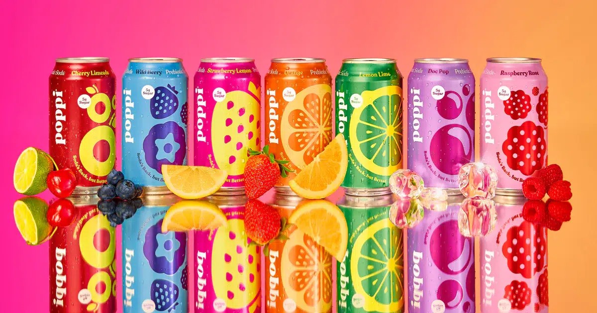 Row of fruit and Poppi soda cans in bright colors and assorted flavors
